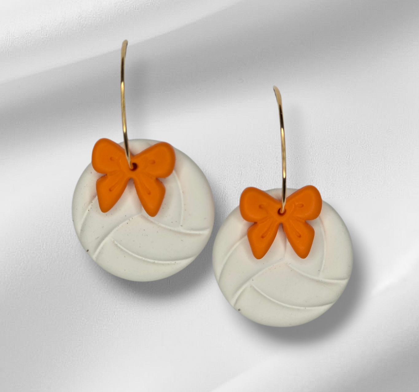 Volleyball with bow hoop earrings